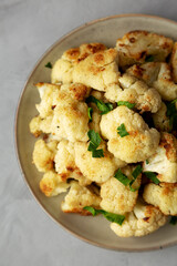 Homemade Roasted White Cauliflower on a Plate, top view. Flat lay, overhead, from above. Close-up.