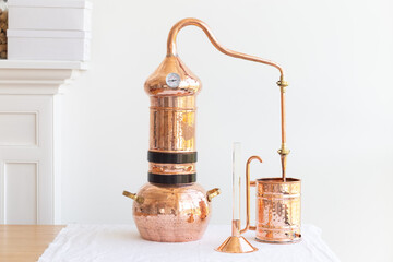 Distillation of lavender essential oil. Copper alambic in a Scandinavian interior. - obrazy, fototapety, plakaty
