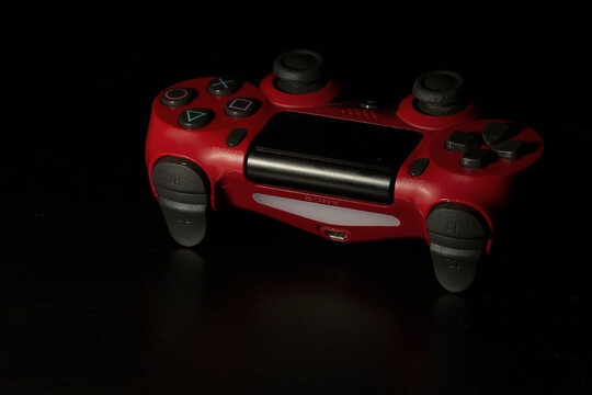 red end black controller sony for ps4, photo taken  in Bucharest on April 8, 2021