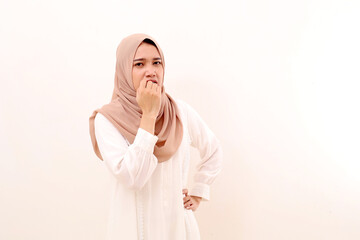 Portrait of young asian muslim woman with afraid face expression. Isolated on white background
