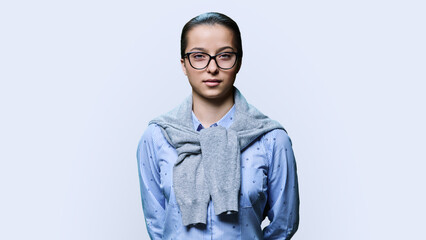 Portrait of teenage student girl looking at camera on white background