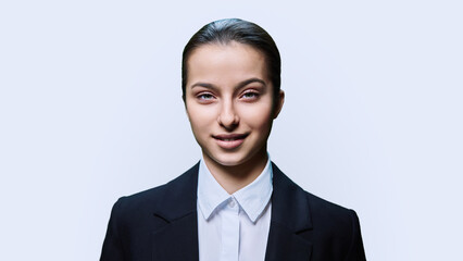 Portrait of teenager girl looking at camera on white background