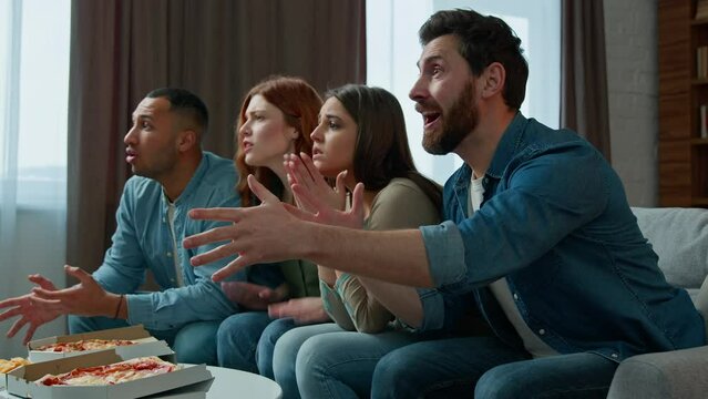 Excited football fans diverse ethnic friends multiracial men women watch tv sport soccer game celebrate goal favorite team win championship victory in television multiethnic people cheering screaming