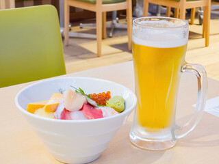Close up shot of cold beer with fresh Japanese style sashimi