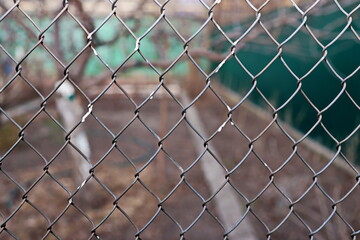 Fototapeta premium Metal corrugated sheets and metal mesh used for fences. Elements of doors and locks. Background.