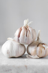 Garlic bulbs on a marble tray, garlic, raw garlic, Allium sativum