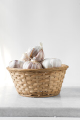 Garlic bulbs in a woven basket, garlic in woven wood basket, raw garlic, Allium sativum
