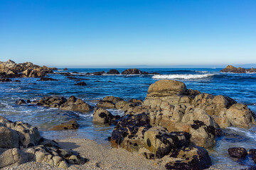 Rock formations on a beach in Monterey Bay with a ocean view
