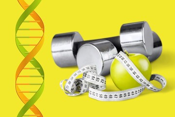 DNA structure, sport dumbbells and tape measure on desk