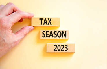 Tax season 2023 symbol. Concept words Tax season 2023 on wooden blocks on a beautiful white table...