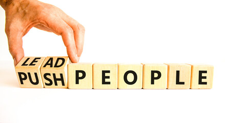 Lead or push people symbol. Concept word Lead people and Push people on wooden cubes. Beautiful white table white background. Businessman hand. Business Energy or hunger crisis concept. Copy space.