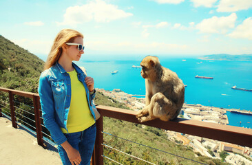 Woman tourist and macaque monkey. Gibraltar, United Kingdom