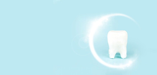 Dental care concept, Protective vortex around tooth model on blue background with copy space.