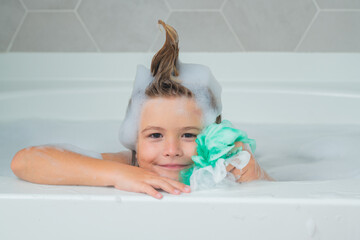 Naklejka premium Kids shampoo. Foam on child head. Child bathes in a bath with foam.
