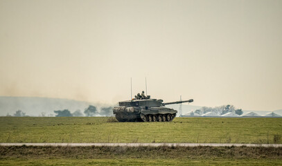 British army FV4034 Challenger 2 ii main battle tank in action, gun turret pointing forwards,...