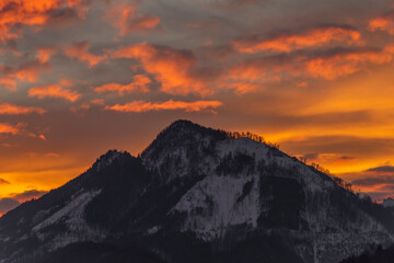 Winter morning with color clouds and big dark hills