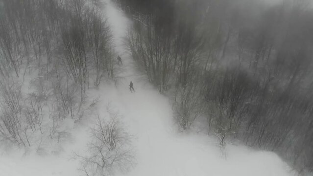Drone shot of people skiing on Mount Himba. Ski resort Pylypets in the Carpathians of Ukraine. Prepared tracks for skiers and snowboarders.The longest ski run in Ukraine. Cableway- Borzhava lifts