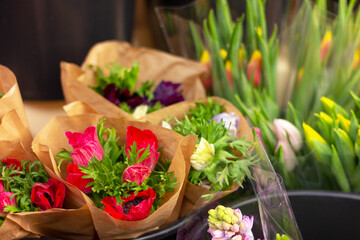 bouquets of spring flowers in wrapper in florist shop
