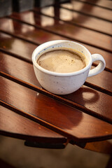 cup of coffee and spring flowers primrose multicolored on the table copy space food background rustic top view