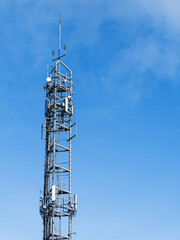 Cell tower UK with copy space against a blue sky
