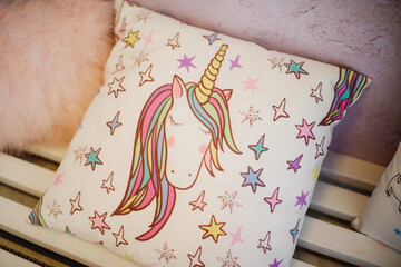 children's pillow, pillowcase with unicorn motif. Birthday in unicorn style, decorating ideas. Happy childhood concept
