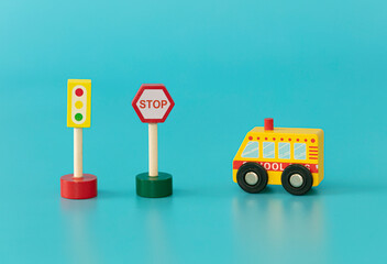 Wood sings: traffic lights and stop sings with school bus on blue background isolated. Symbols:...