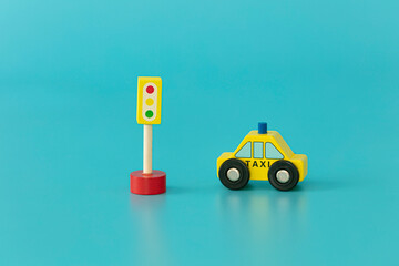 Wood sings: stop sing with yellow taxi on blue background isolated. Symbols: wood toys for kids.