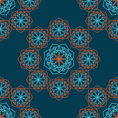 Mandala seamless pattern in green and orange colors for fabric, wallpaper, packaging.Vector illustration