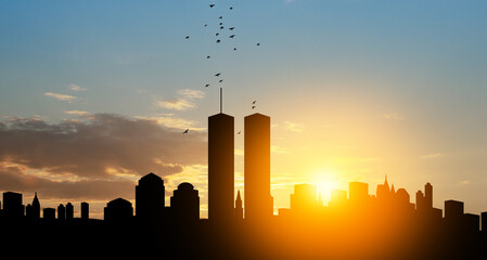 New York skyline silhouette with Twin Towers and birds flying up like souls at sunset. 09.11.2001...