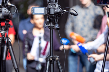 Press conference. Filming media or news event with video or television camera.