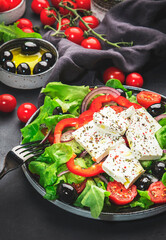 Vegetable greek salad with feta cheese, olives, tomatoes, paprika, cucumber and red onion, healthy...
