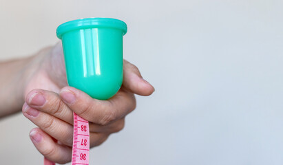 weight loss nutrition get slim fit concept.woman holding vacuum cup for massage measure tape...