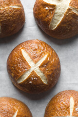 Pretzel buns on a baking sheet, German laugenbroetchen, lye buns on a baking tray