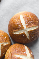 Pretzel buns on a baking sheet, German laugenbroetchen, lye buns on a baking tray