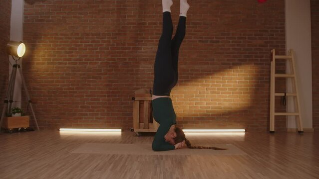 Woman doing yoga handstand balancing for mind and body wellbeing