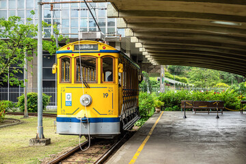 The famous old tram Bonde de Santa Teresa in Rio de Janeiro, Brazil. Yellow tram traveling through...