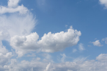 Fototapeta premium Blue sky and white clouds floated in the sky on a clear day with warm sunshine combined with cool breeze blowing against the body resulting in a miraculous refreshing like paradise.