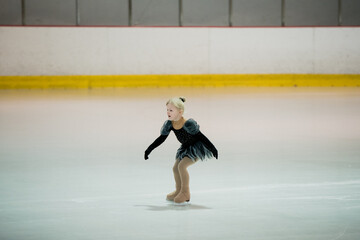 Figure skating of a little 4 year old girl. First competition. Excitement, pride.