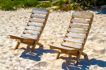 Palms parasols sun loungers beach resort Playa del Carmen Mexico.