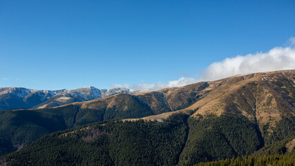 idyllic mountain landscape, with the peak covered with snow, early spring