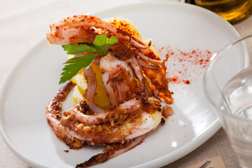 Plate of appetizing roasted shrimps served with lemon and herbs