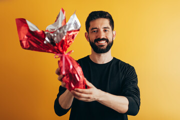 Happy Easter. Happy man holding chocolate easter egg
