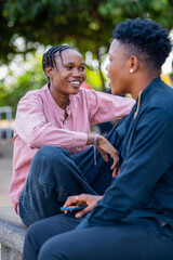 Two queer masculine women talking at the park	