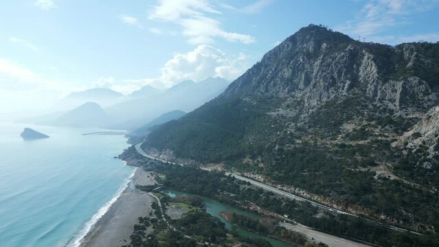 Amazingly beautiful aerial view of the mountains on the seashore with a highway passing at the foot. The concept of traveling by car along the Mediterranean coast. High quality 4k footage