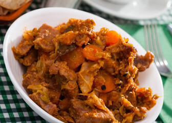 Tasty stew of cabbage with boneless pork and sliced carrots..