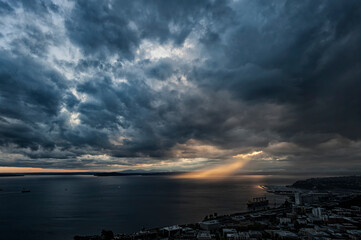 Sun breaking through the clouds over Puget Sound;  Seattle, Washington
