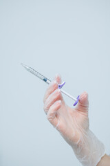 Female hand in gloves with syringe in hand. Syringe for injections in cosmetology