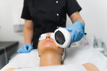 Woman getting an professional laser face treatment. High quality photo
