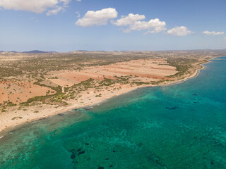 Beautiful azure sea and sandy shore. Wild nature. Warm summer photo. Top view, drone filming.