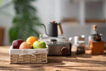 Lovely basket of fresh fruit with coffee up and coffee pot in the background.
